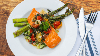 Cooked salmon and asparagus on a plate ready to be eaten. Cooked salmon and asparagus on a plate ready to be eaten.
