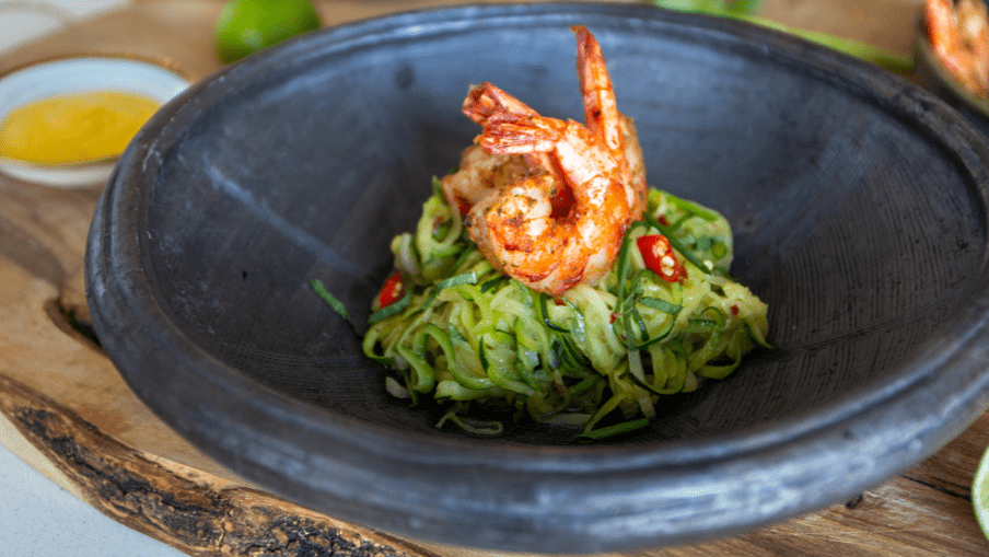 Cooked shrimp on top of zucchini noodles in a bowl with mango sauce on the side. 01-elements-placeholder-default-16-9_8.png