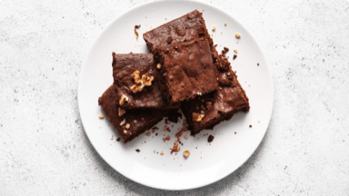 Fudgy chocolate and walnut brownies on a plate. Fudgy chocolate and walnut brownies on a plate.