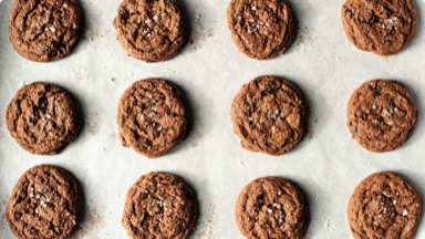 Fudgy chocolate cookies on parchment paper.  Fudgy chocolate cookies on parchment paper.